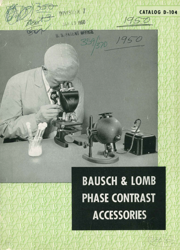 A person looking through a microscope
Description automatically generated