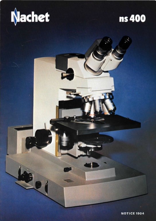 A white and black microscope
Description automatically generated