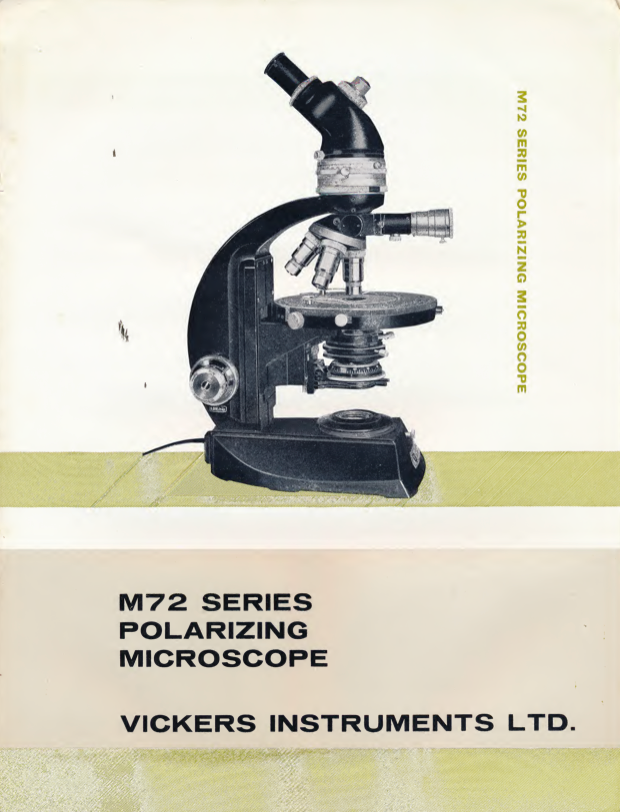 A black and white cover with a microscope
Description automatically generated