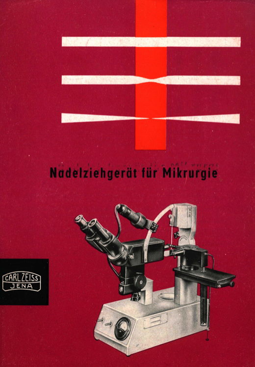 A red cover with a microscope
Description automatically generated