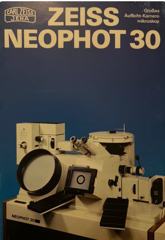 A book cover with a white and black device
Description automatically generated