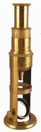 A gold metal object with a hole
Description automatically generated