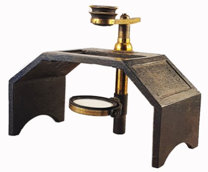 A metal and gold object with a magnifying glass
Description automatically generated