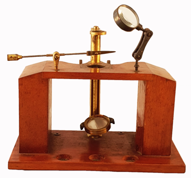 A wooden device with a magnifying glass
Description automatically generated