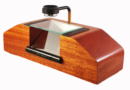 A wooden object with a glass and a lens
Description automatically generated